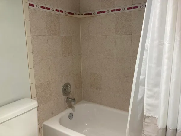 a bathroom with a tub and a shower curtain