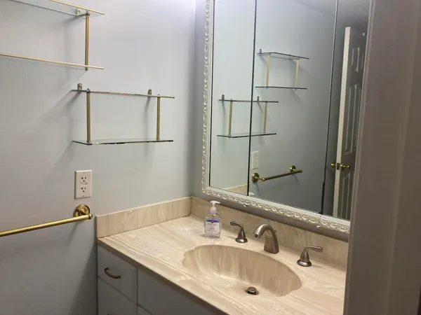 a bathroom with a sink and a mirror