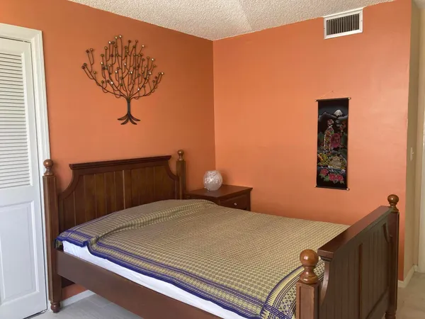 a bedroom with a bed and cabinets