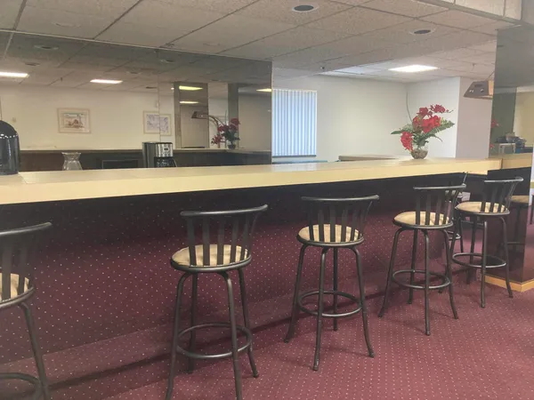 a kitchen with a table chairs and microwave