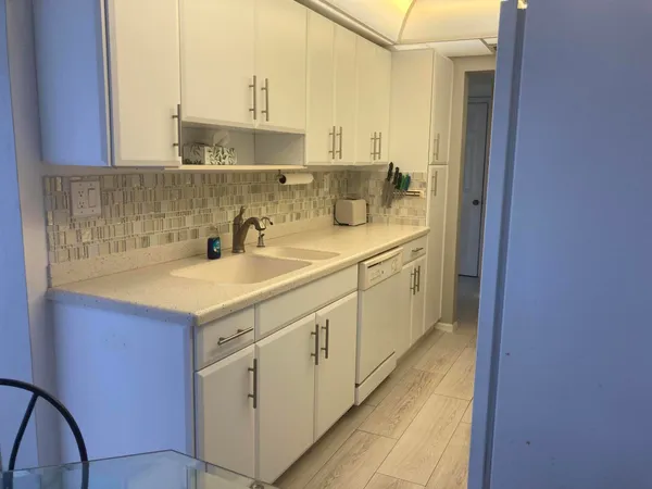 a kitchen with sink cabinets and stove