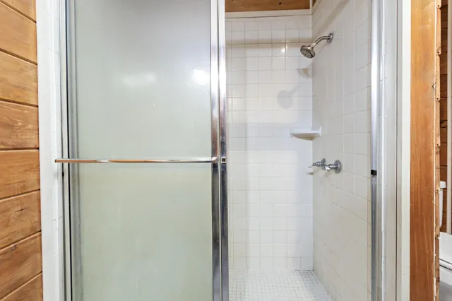 a bathroom with a glass shower door