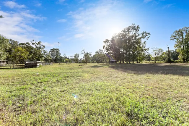 a view of open space with green field and trees