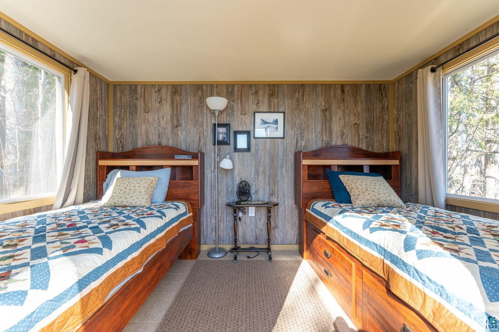 4452 Moccasin Point Road Tower, MN 55790 - Photo 37 of 44 Room featuring wood-finish paneling walls and two large windows