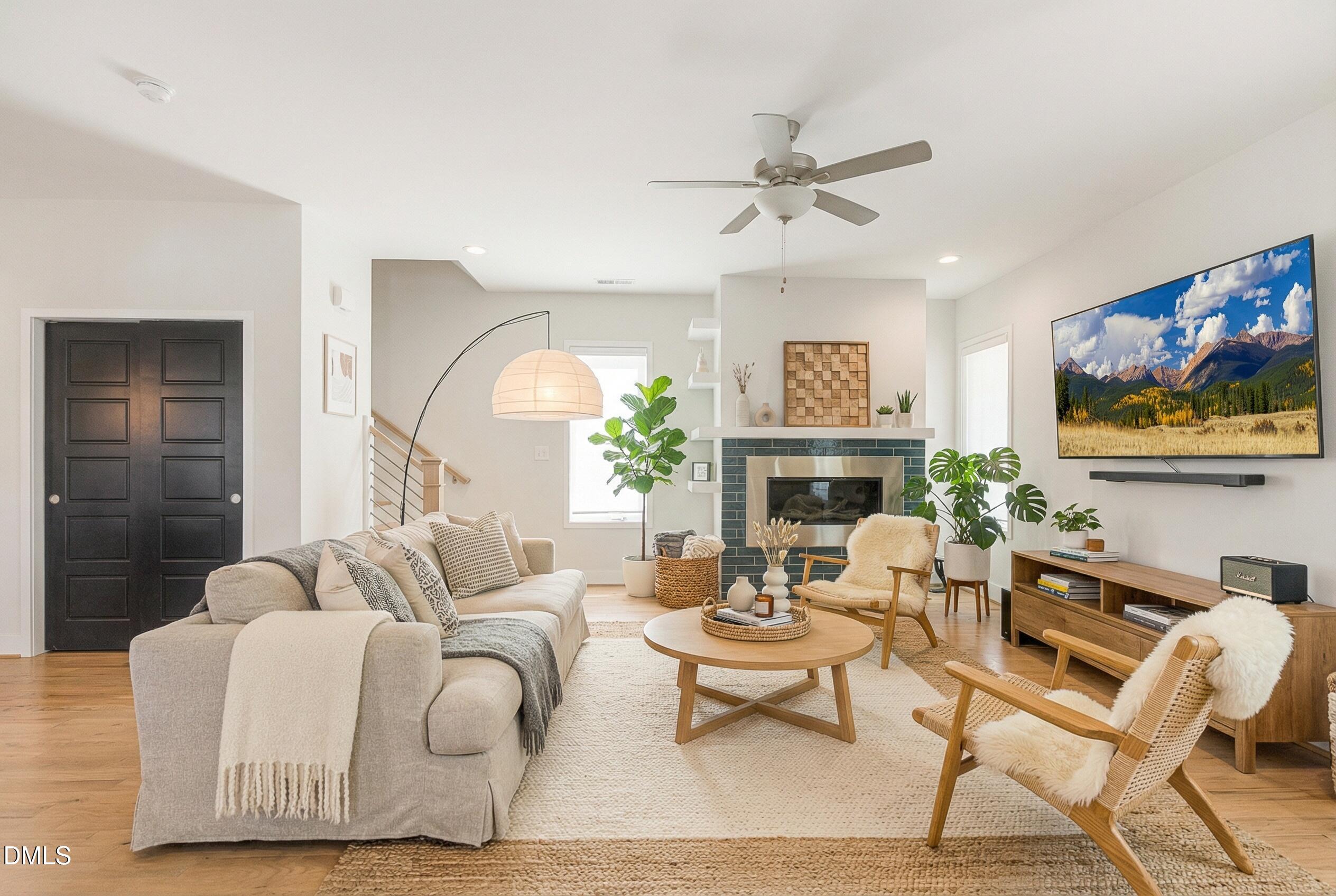 a living room with fireplace furniture and a flat screen tv
