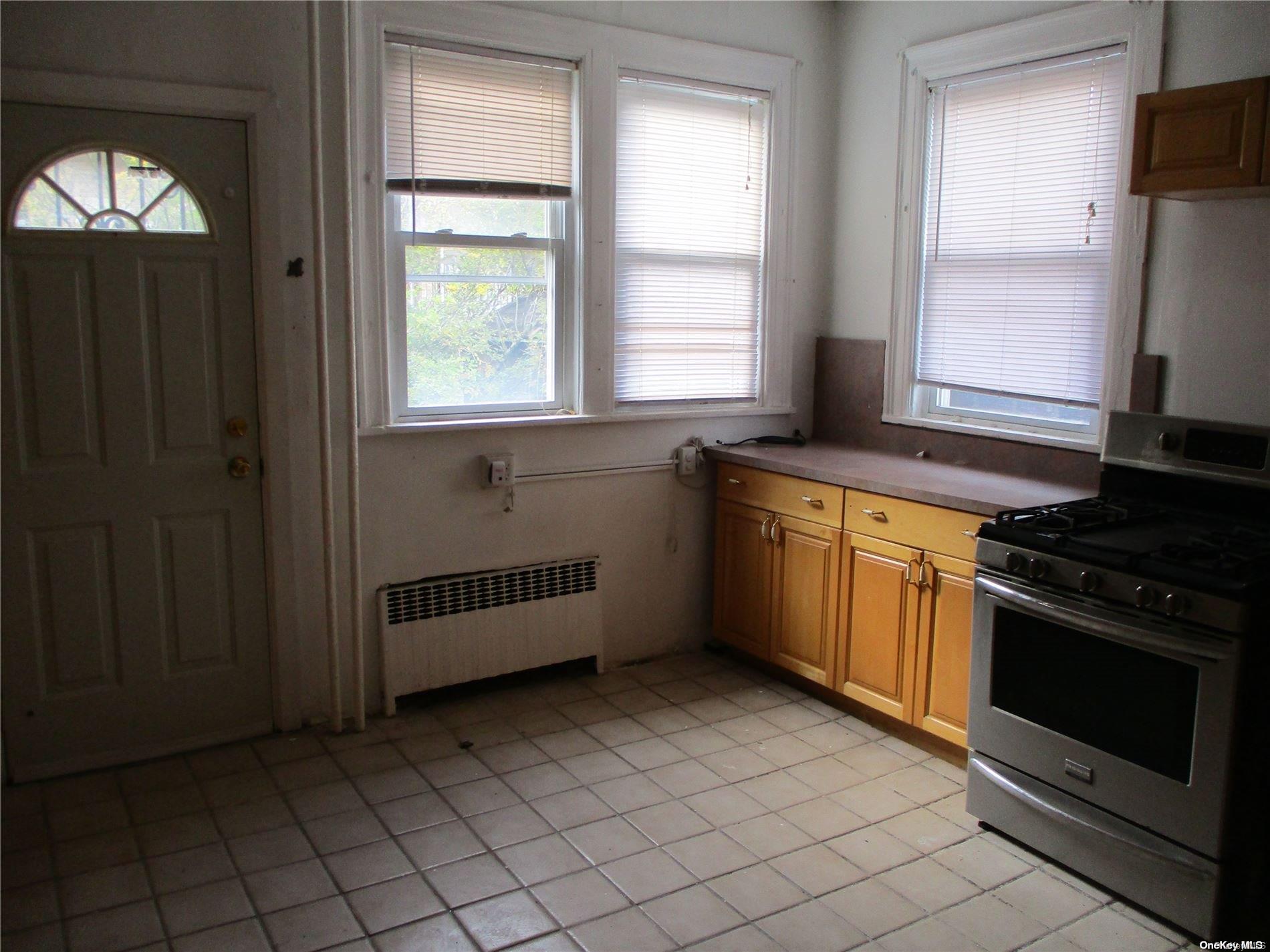 135 Beach 124th Street Queens, NY 11694 - Photo 15 of 25 a kitchen with stainless steel appliances a stove sink and window