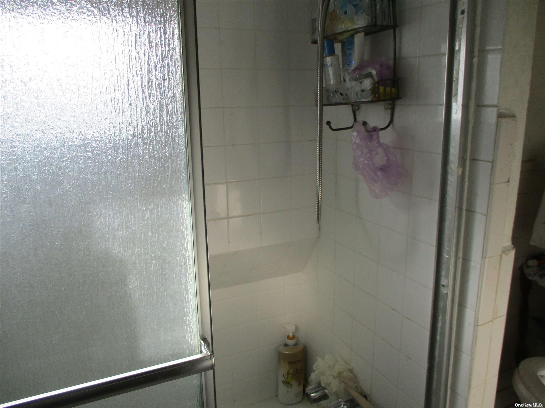 135 Beach 124th Street Queens, NY 11694 - Photo 19 of 25 a bathroom with a glass shower door
