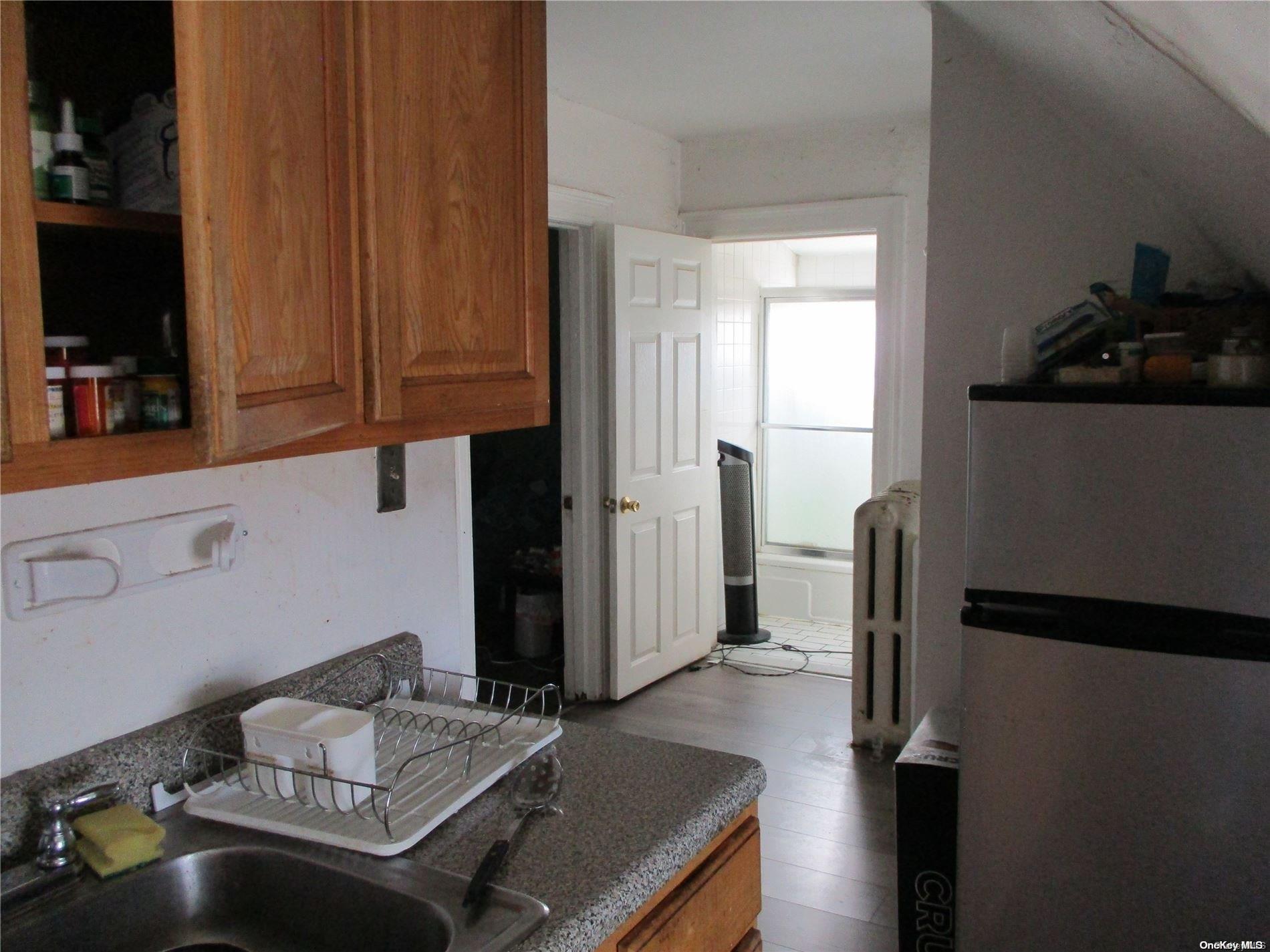 135 Beach 124th Street Queens, NY 11694 - Photo 20 of 25 a bedroom with a bed and furniture