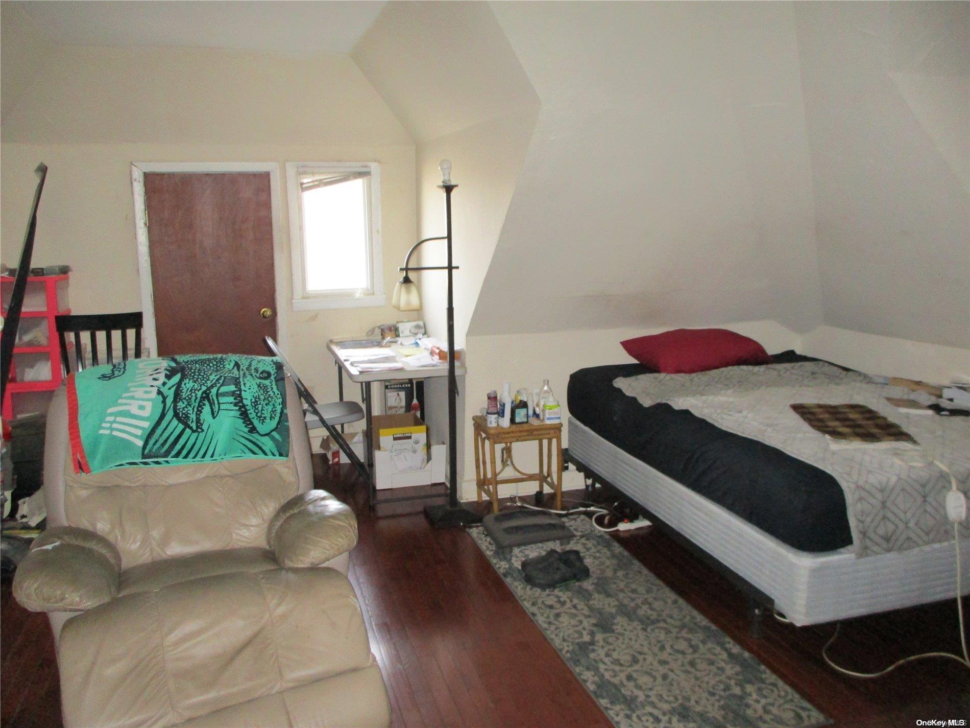 135 Beach 124th Street Queens, NY 11694 - Photo 21 of 25 a bedroom with a bed and a table