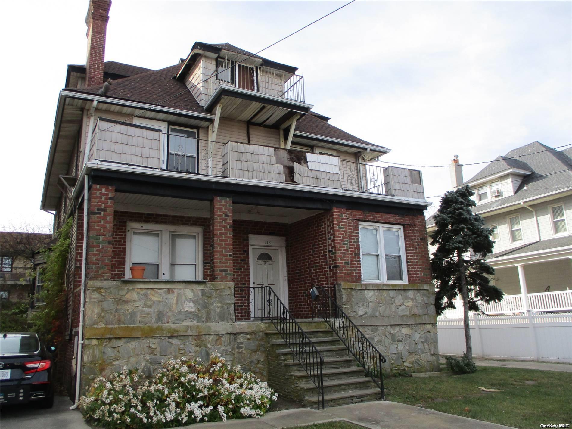 135 Beach 124th Street Queens, NY 11694 - Photo 25 of 25 a front view of a house with a garden