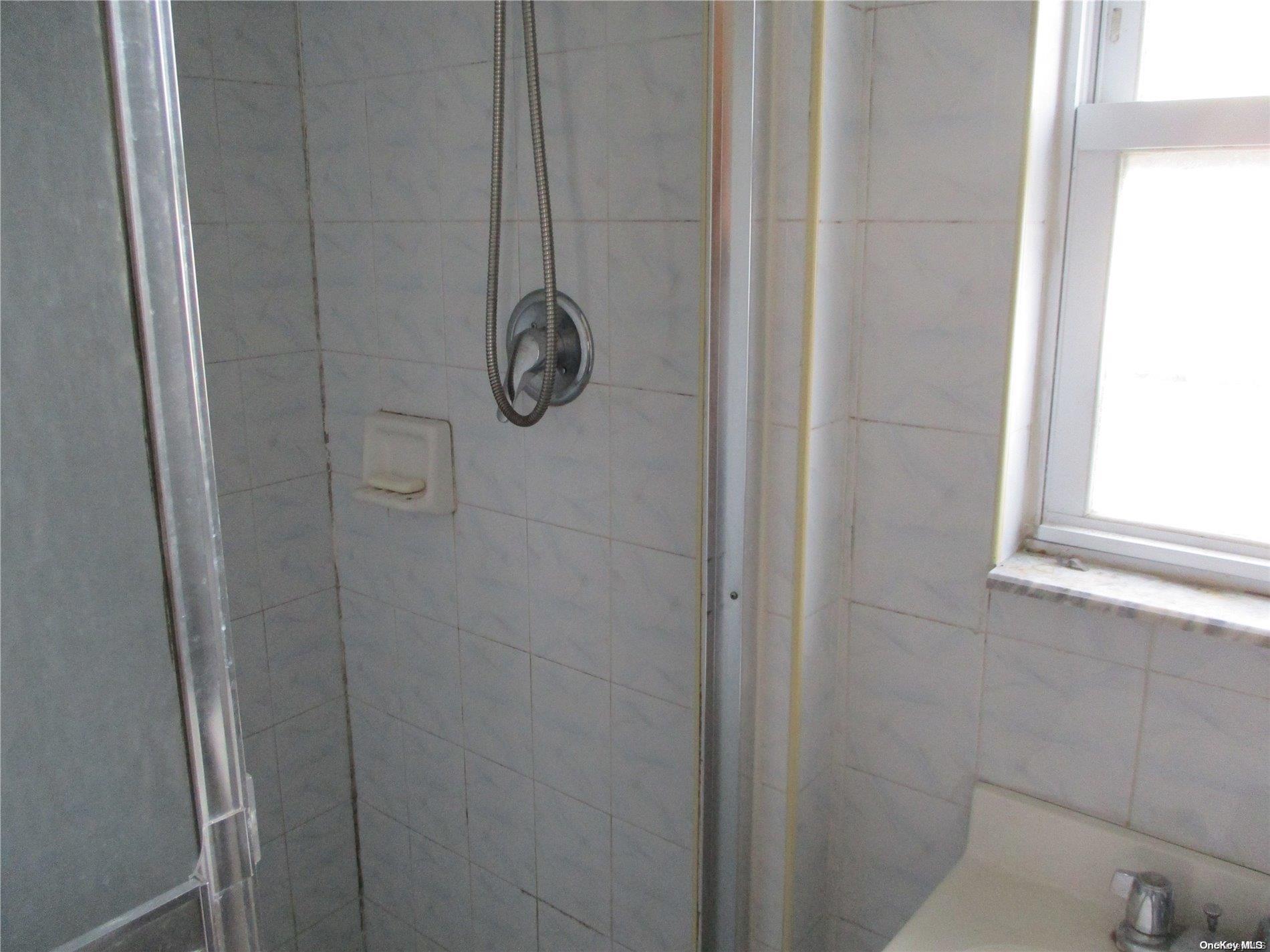 135 Beach 124th Street Queens, NY 11694 - Photo 9 of 25 a bathroom with a shower