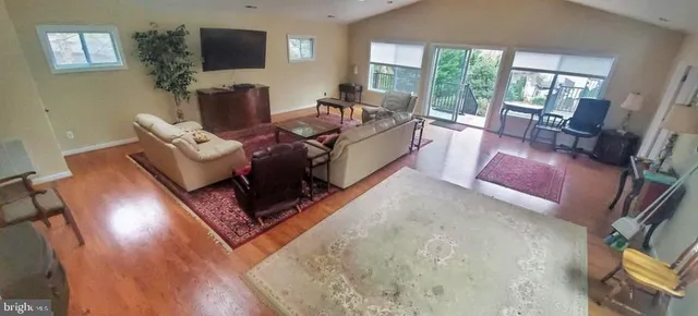 a living room with furniture rug and a large window