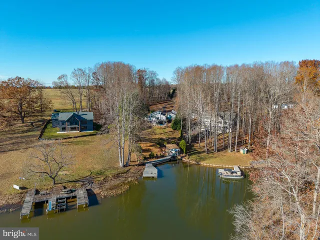 a view of a ocean with boats and trees in the background