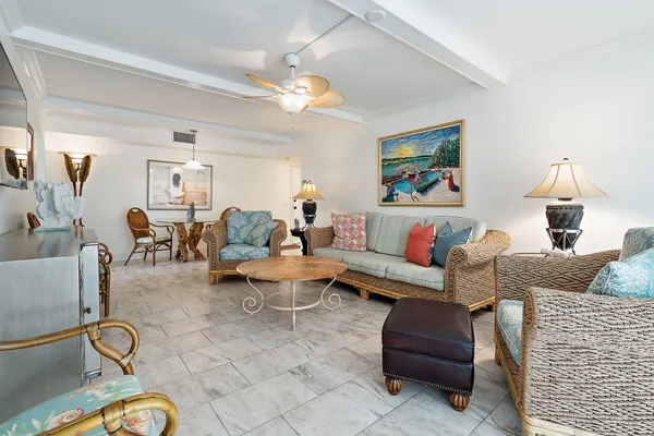 a living room with furniture a flat screen tv and a floor to ceiling window