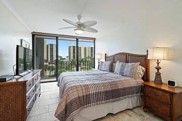 a bedroom with a large bed and a large window