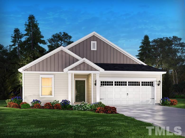a view of a white house with yard and plants