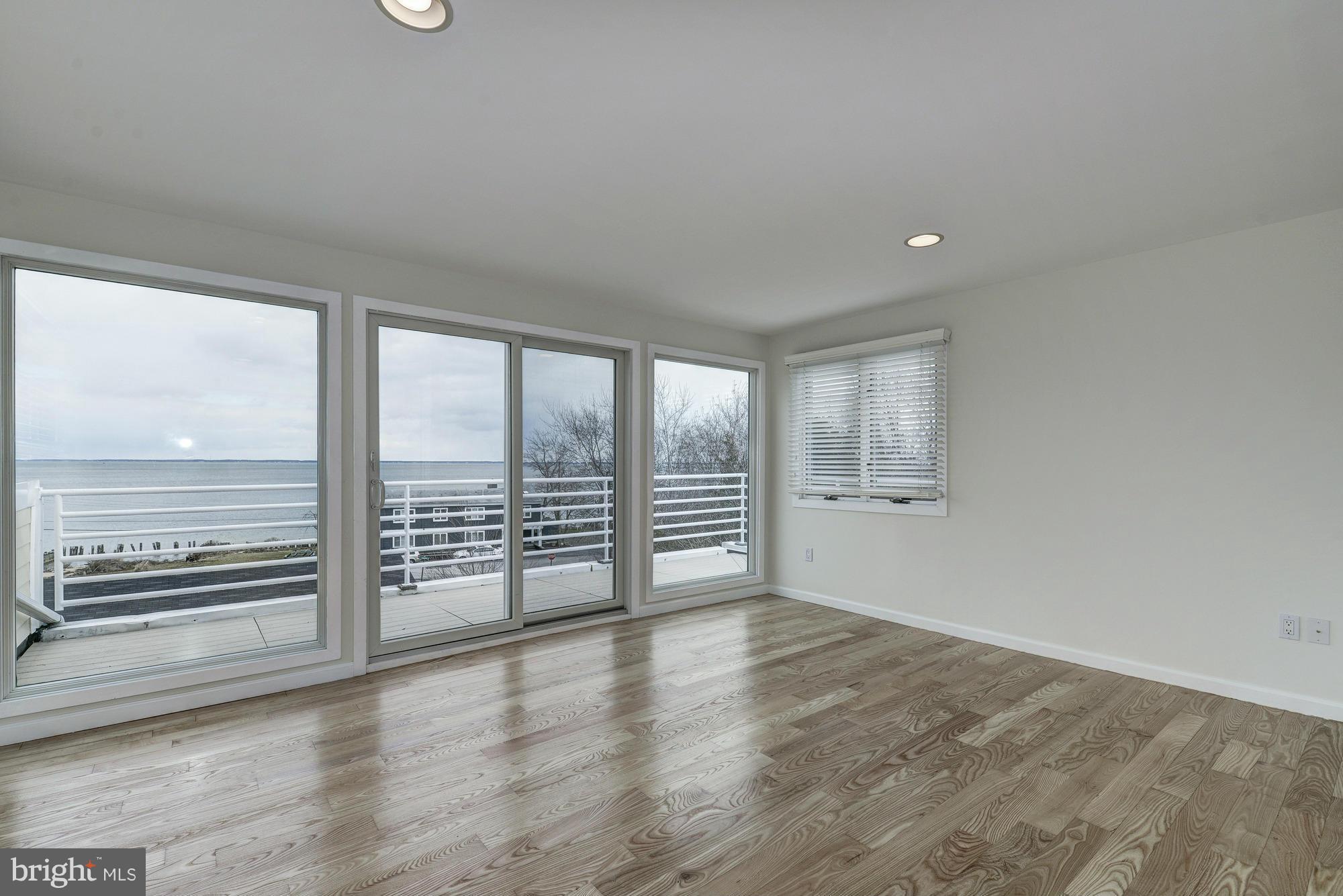 1426 Howard Road Annapolis, MD 21403 - Photo 21 of 30 an empty room with wooden floor and windows