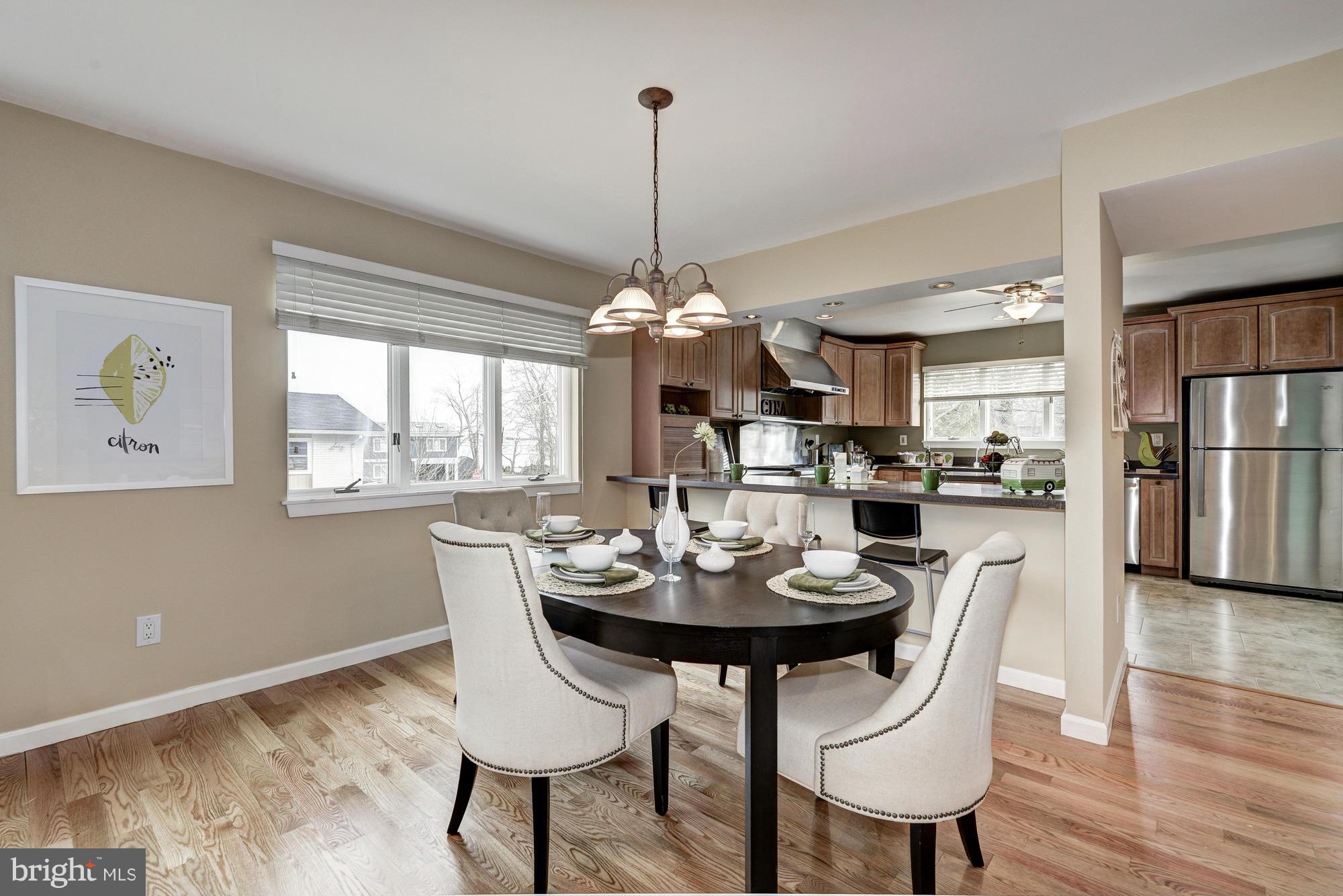 1426 Howard Road Annapolis, MD 21403 - Photo 7 of 30 a dining room with furniture a chandelier and wooden floor