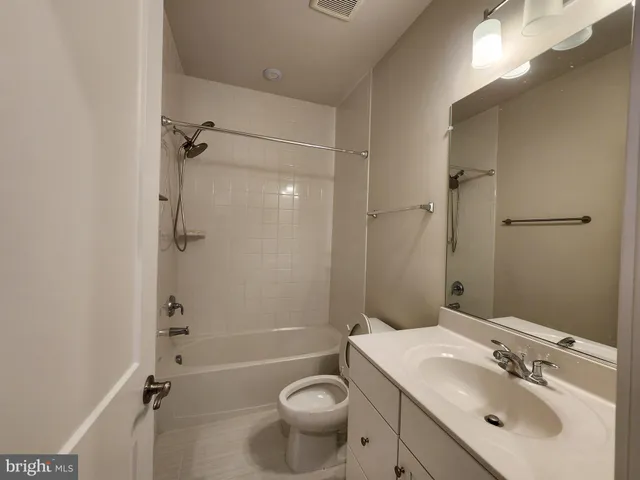 a bathroom with a sink toilet tub and shower