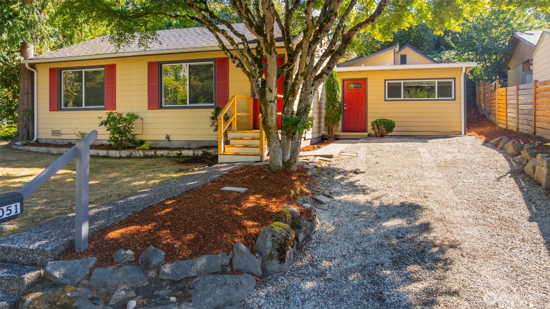 a front view of house with yard space and trees around