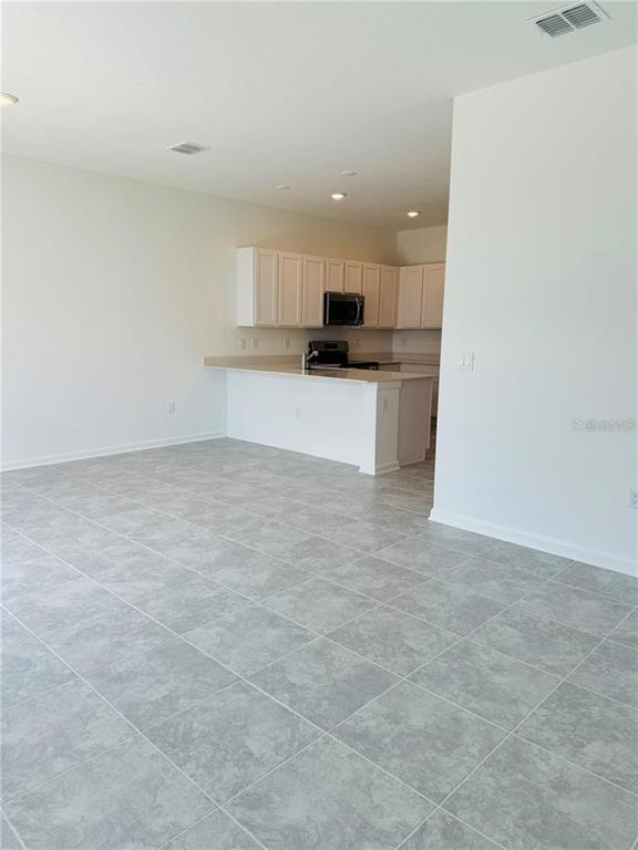 2452 Skyline Loop Kissimmee, FL 34758 - Photo 6 of 12 a view of kitchen with refrigerator sink and cabinets