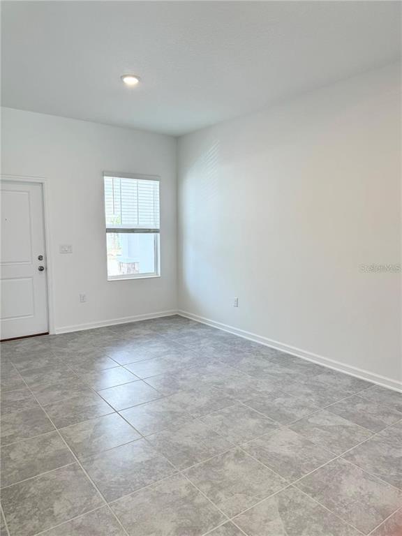 2452 Skyline Loop Kissimmee, FL 34758 - Photo 8 of 12 an empty room with windows