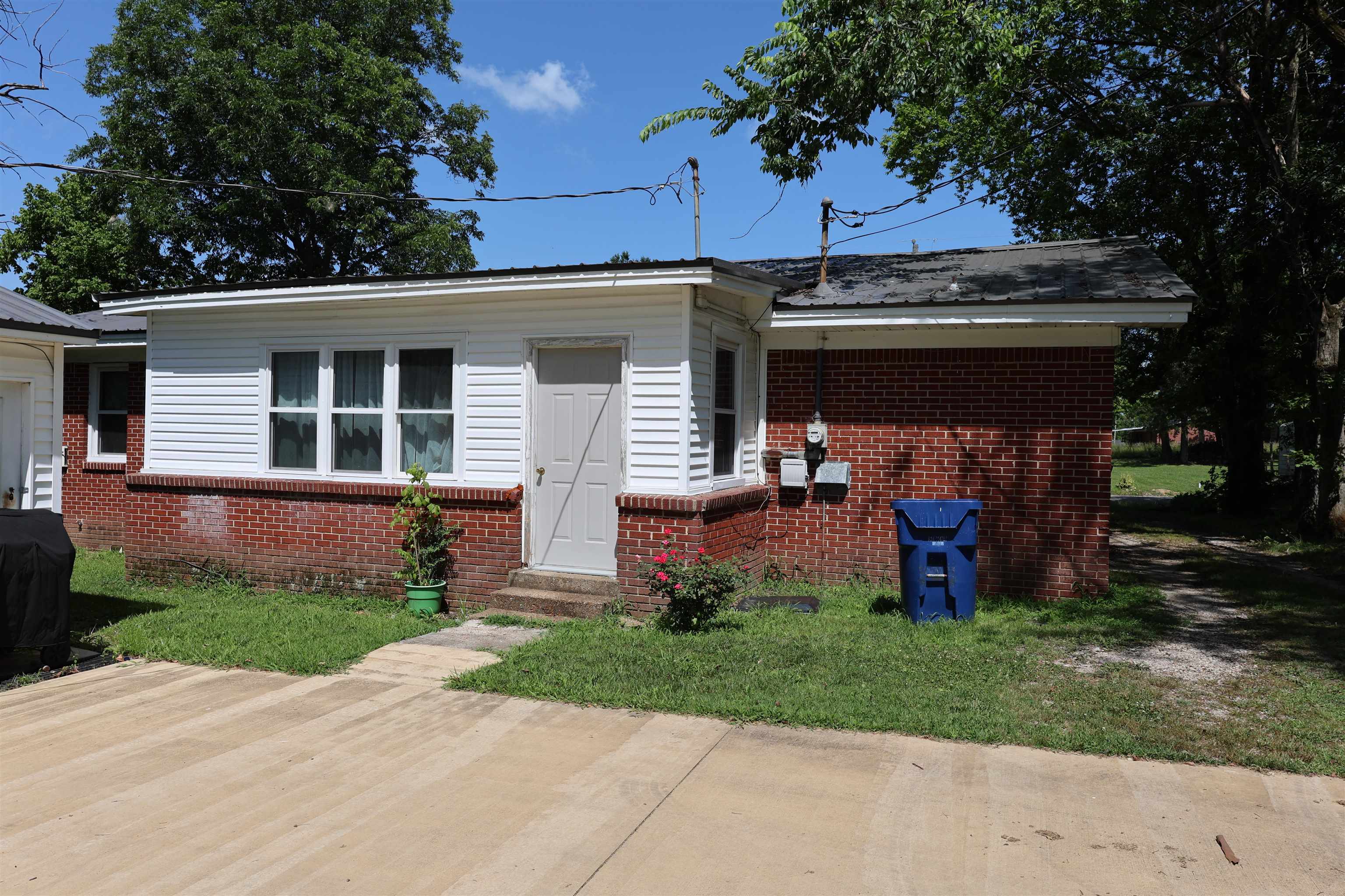 123 North Magnolia Street Adamsville, TN 38310 - Photo 6 of 25 front view of a house with a yard