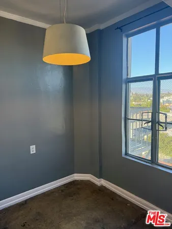 a kitchen with kitchen island granite countertop a sink stove and refrigerator