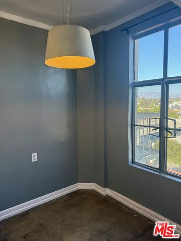 a kitchen with kitchen island granite countertop a sink stove and refrigerator
