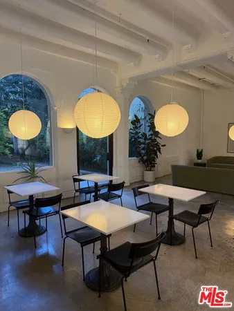 a view of a a dining room with furniture window and wooden floor