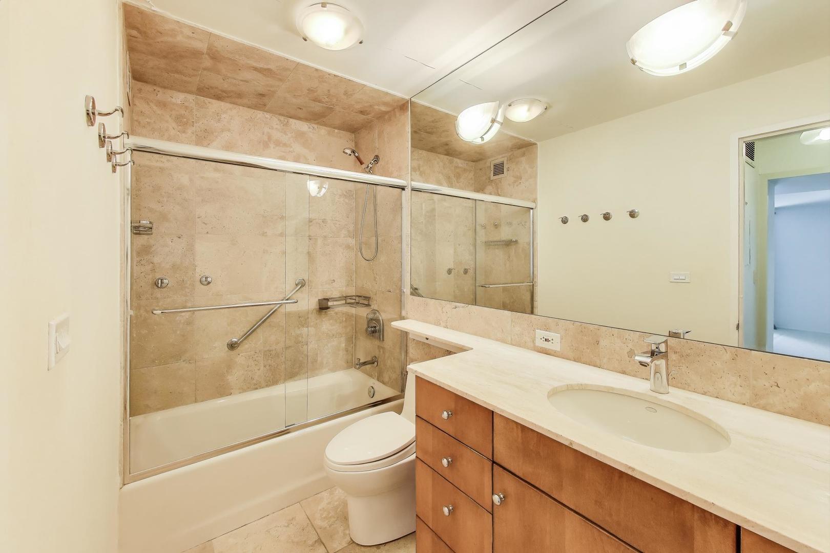 201 East Chestnut Street, Unit 19F Chicago, IL 60611 - Photo 14 of 36 a bathroom with a sink a toilet and shower
