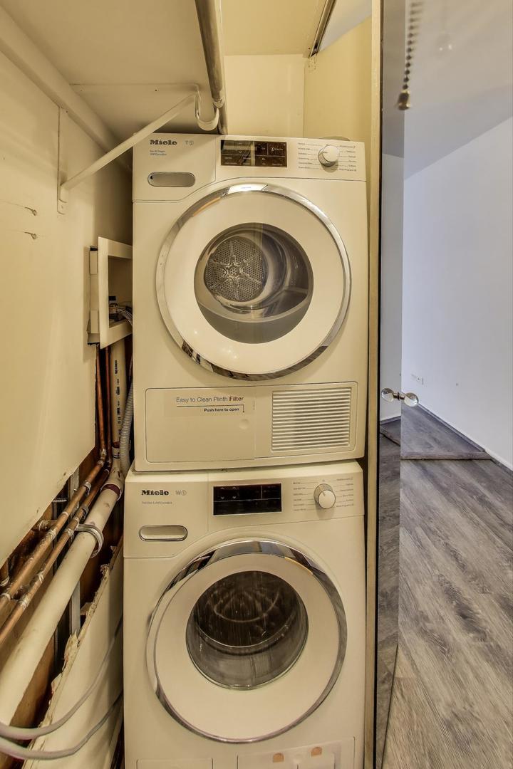 201 East Chestnut Street, Unit 19F Chicago, IL 60611 - Photo 16 of 36 a utility room with dryer and washer
