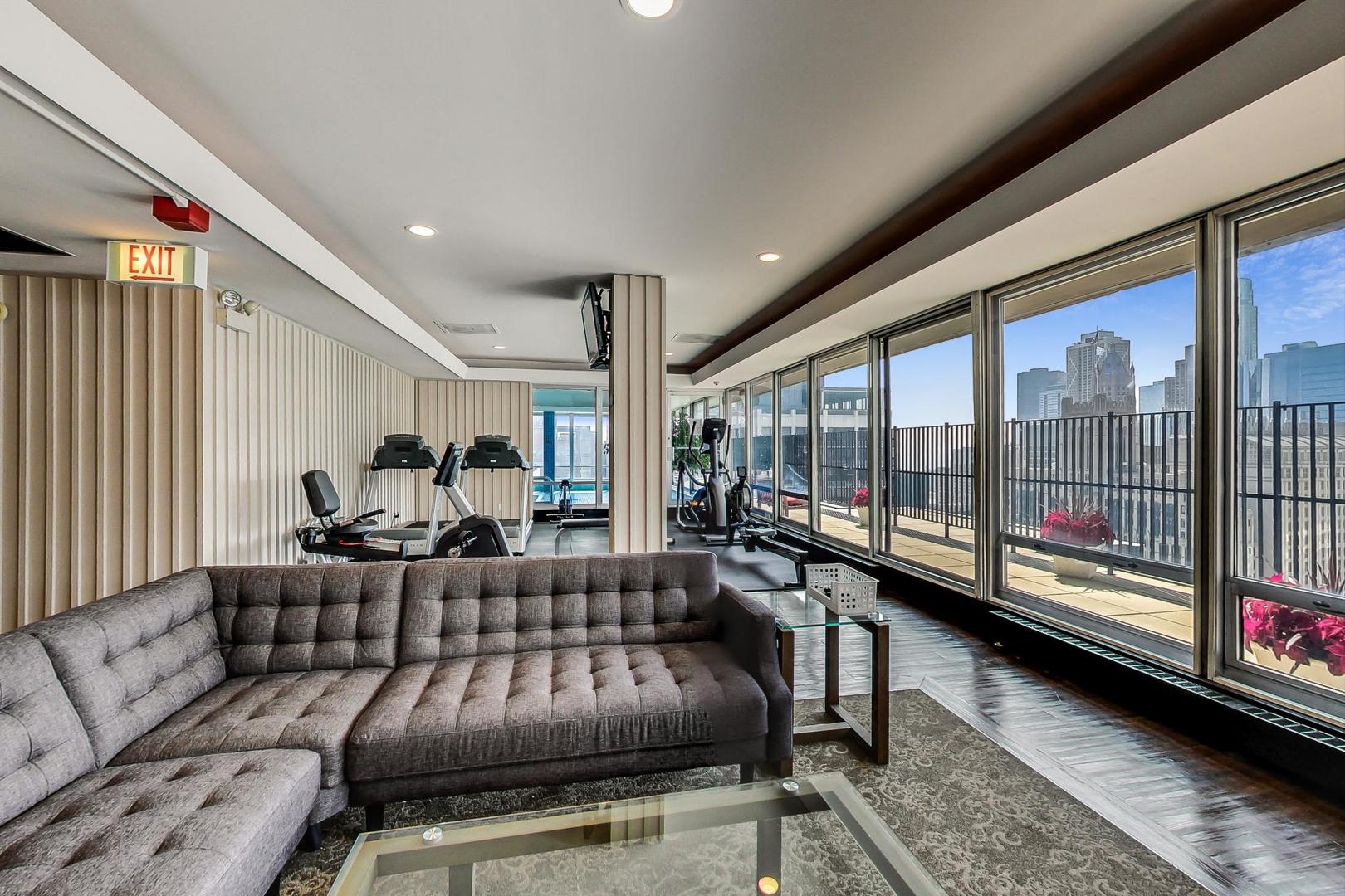 201 East Chestnut Street, Unit 19F Chicago, IL 60611 - Photo 23 of 36 a living room with furniture and a large window