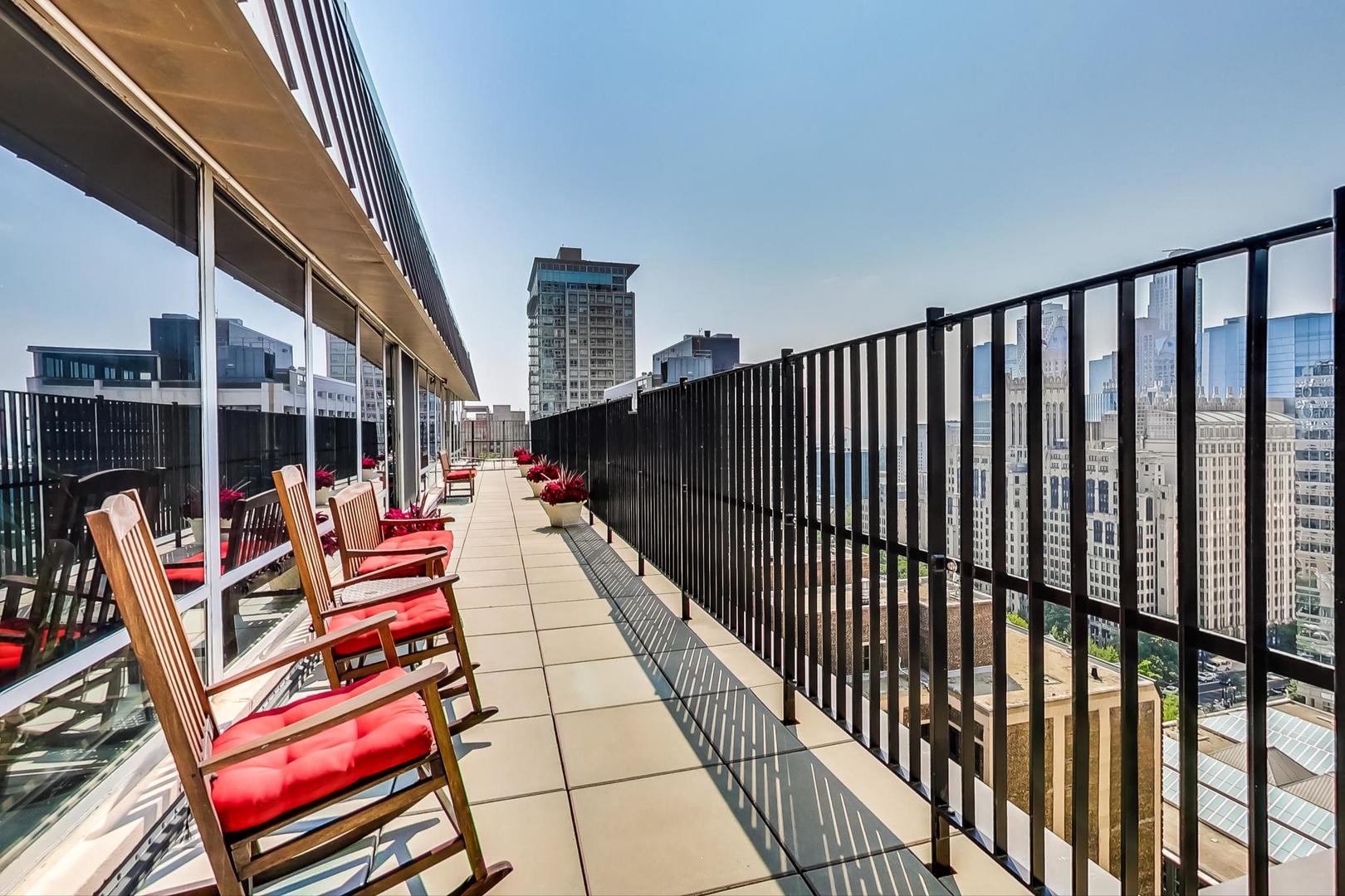 201 East Chestnut Street, Unit 19F Chicago, IL 60611 - Photo 33 of 36 a balcony with couch and wooden floor