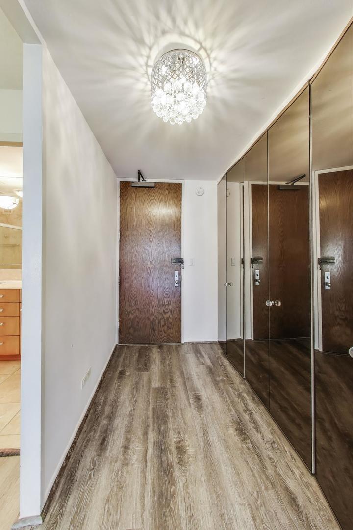 201 East Chestnut Street, Unit 19F Chicago, IL 60611 - Photo 4 of 36 a view of a hallway with a chandelier