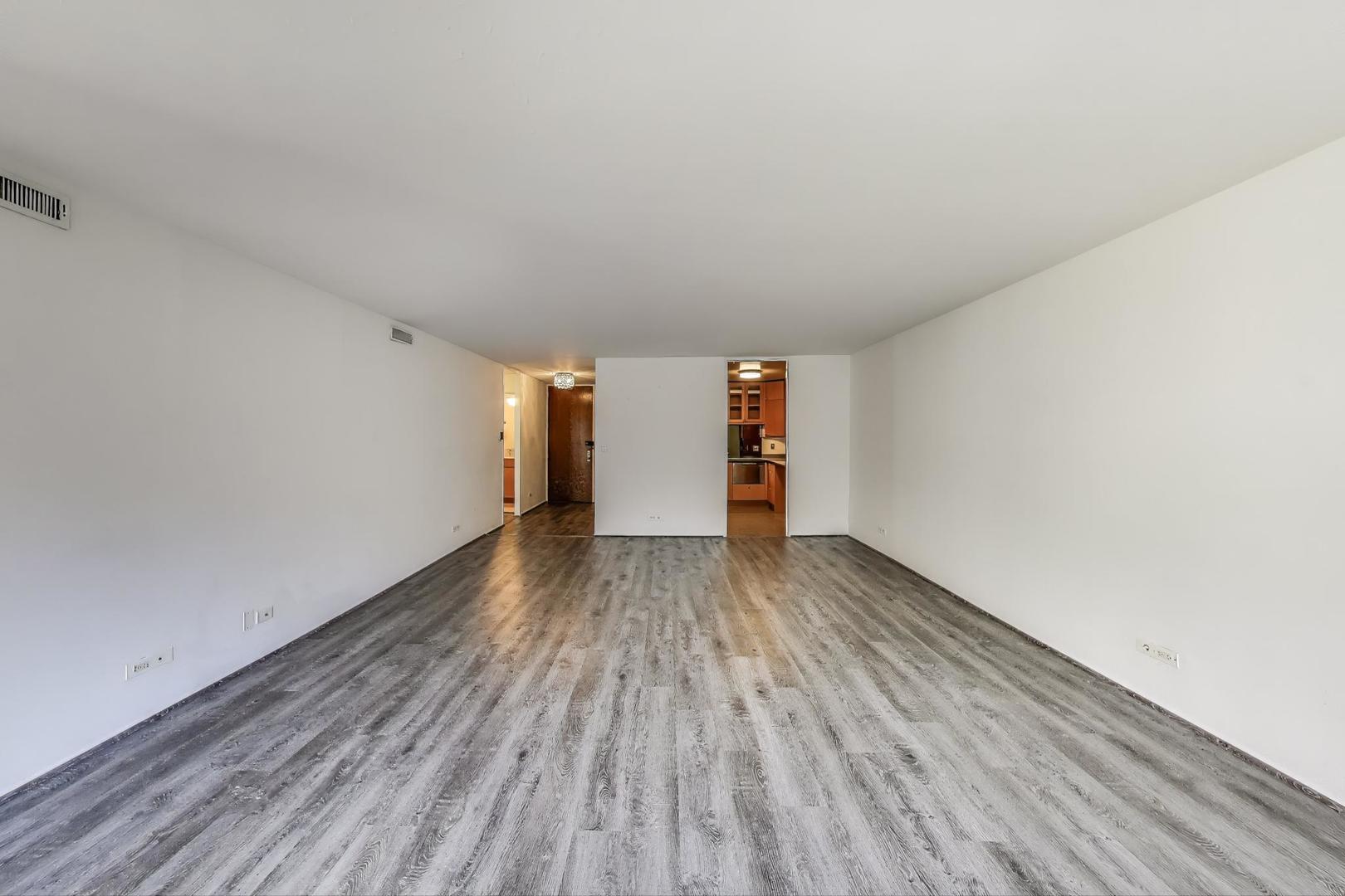 201 East Chestnut Street, Unit 19F Chicago, IL 60611 - Photo 5 of 36 a view of empty room with wooden floor