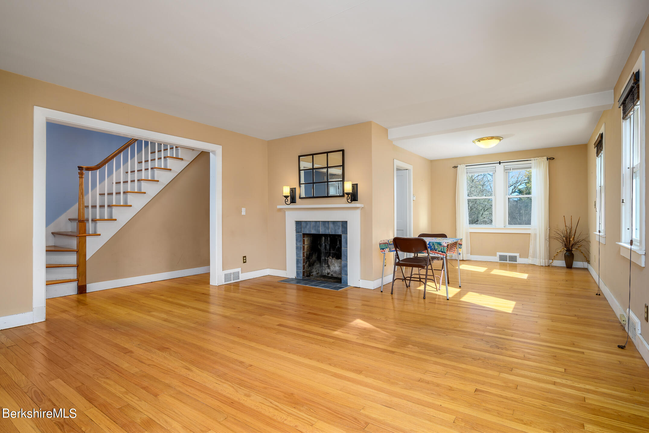 186 Stratton Road Williamstown, MA 01267 - Photo 4 of 33 a view of a livingroom with furniture a fireplace wooden floor and windows