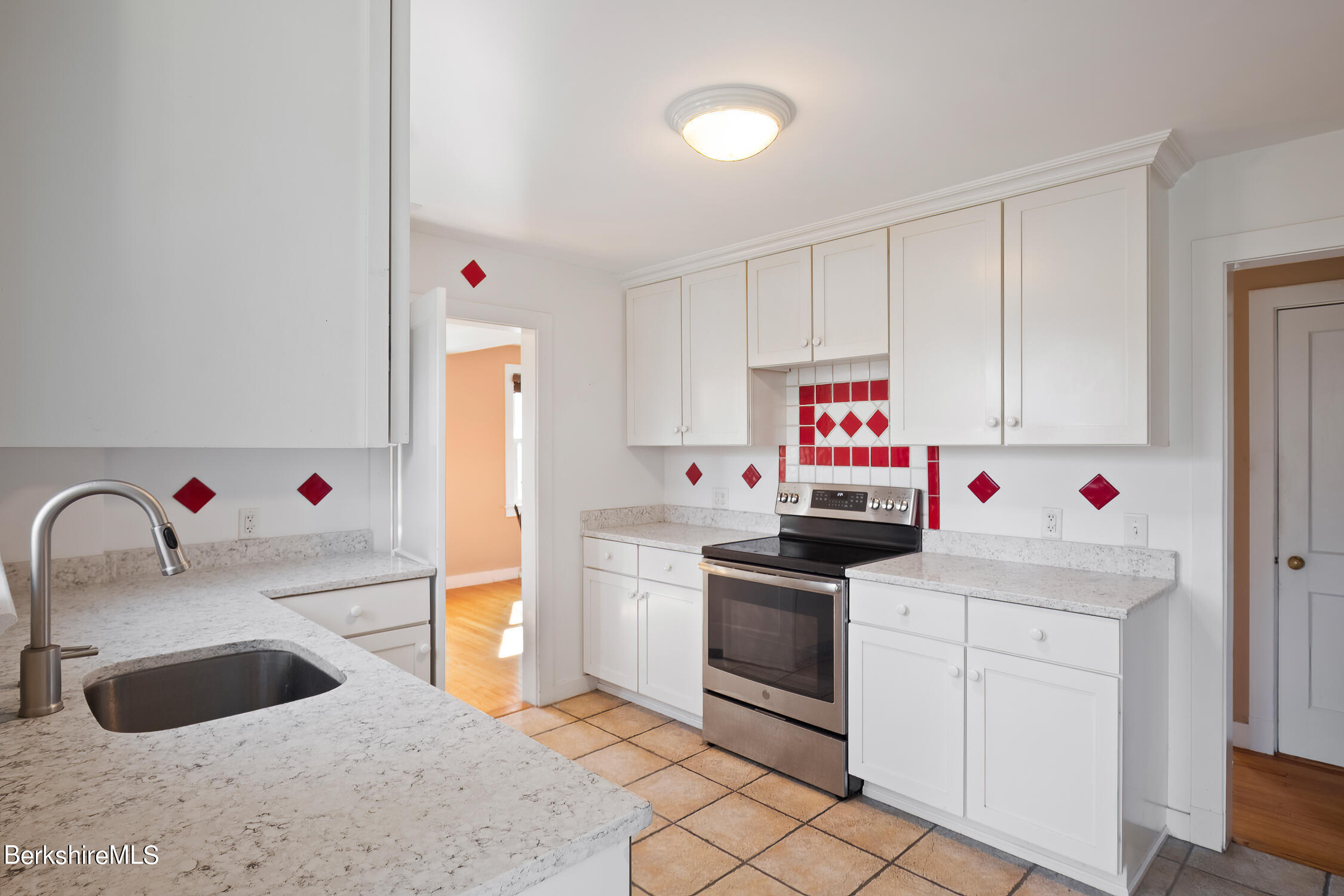 186 Stratton Road Williamstown, MA 01267 - Photo 10 of 33 a kitchen with granite countertop a sink and white cabinets