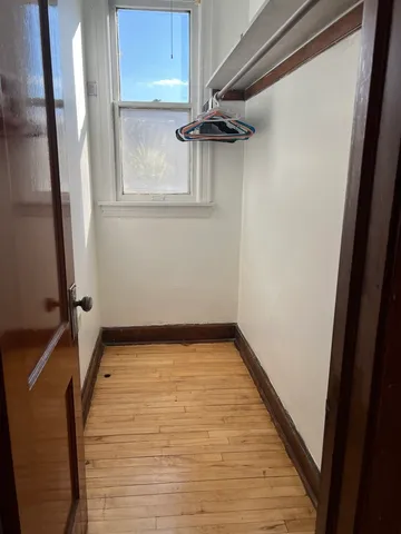 a view of a room with rack on the wall and a window