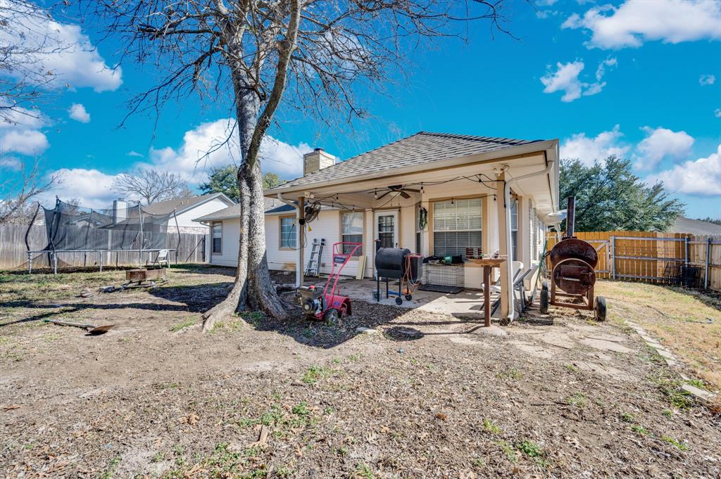 1003 Short Line Boulevard Midlothian, TX 76065 - Photo 11 of 25 Rear view of property with a patio, a ceiling fan, a fenced backyard, and a trampoline