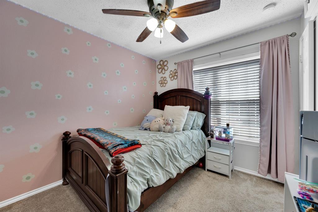 1003 Short Line Boulevard Midlothian, TX 76065 - Photo 21 of 25 Bedroom with wallpapered walls, a textured ceiling, ceiling fan, and light carpet