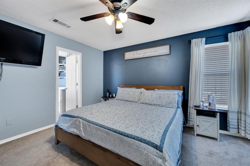 1003 Short Line Boulevard Midlothian, TX 76065 - Photo 23 of 25 Bedroom with carpet, ceiling fan, a textured ceiling, and ensuite bath