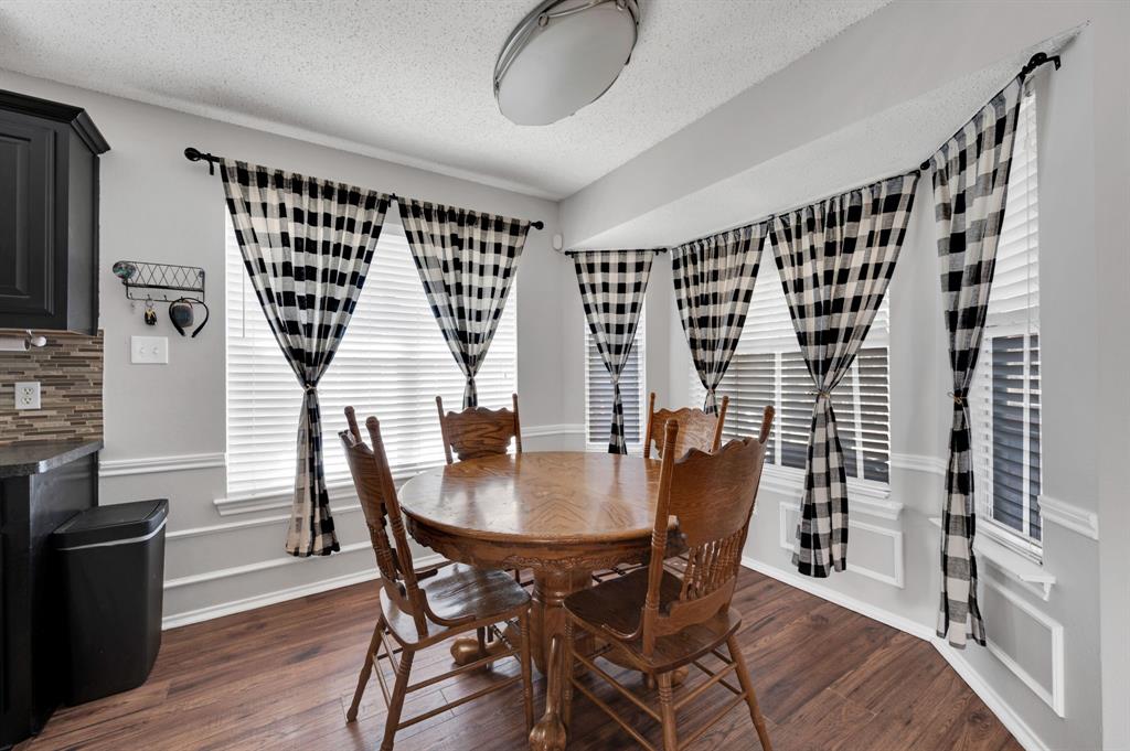 1003 Short Line Boulevard Midlothian, TX 76065 - Photo 3 of 25 Dining area featuring dark wood-style flooring and a textured ceiling