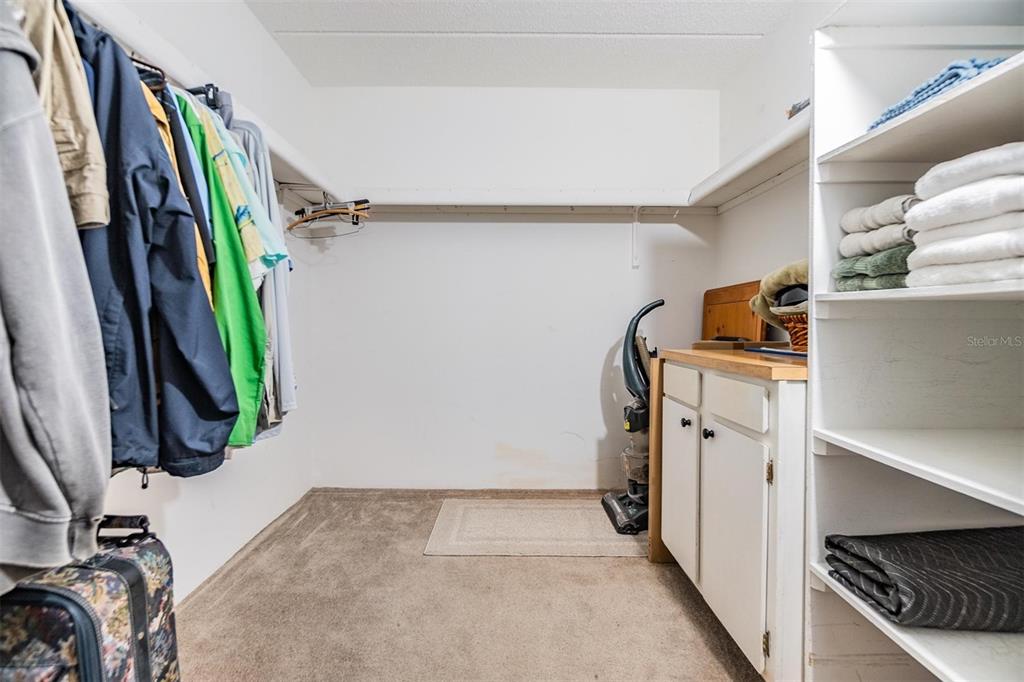 12760 Indian Rocks Road, Unit 104 Largo, FL 33774 - Photo 20 of 37 a view of walk in closet with clothes and shoes