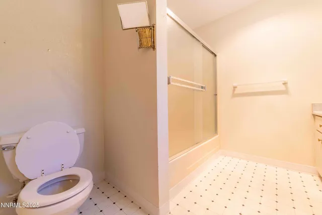 a bathroom with a toilet and a shower