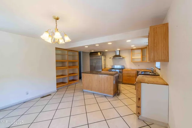 a kitchen with stainless steel appliances granite countertop a sink and cabinets