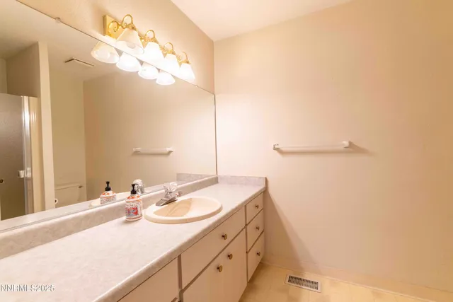 a bathroom with a sink vanity and a mirror