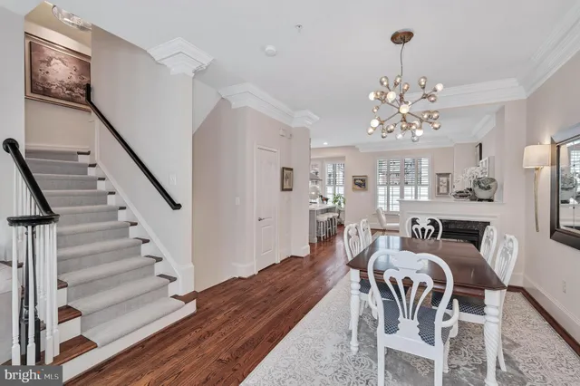 a living room with furniture wooden floor and a large window