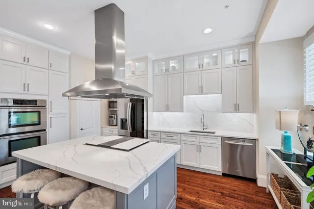 a kitchen with stainless steel appliances granite countertop a stove and a refrigerator