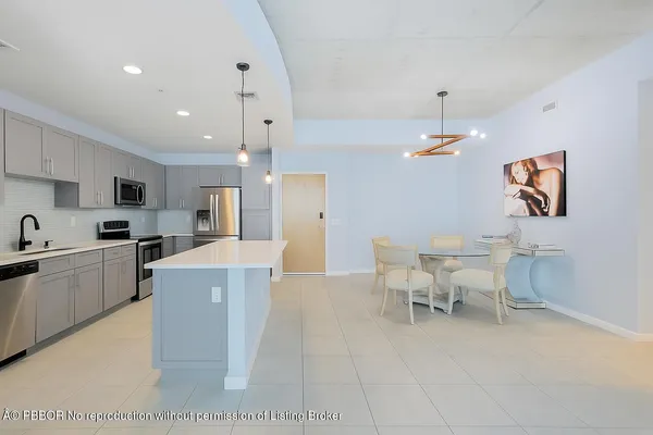 a large kitchen with a table and chairs in it